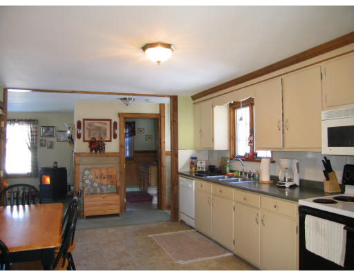 43 Bethany Road Monson, MA 01057 - Photo 12 of 16 a kitchen with sink refrigerator and cabinets