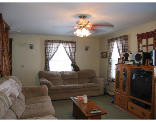 43 Bethany Road Monson, MA 01057 - Photo 9 of 16 a living room with furniture a chandelier and a window