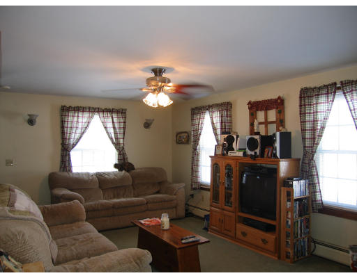 43 Bethany Road Monson, MA 01057 - Photo 10 of 16 a living room with furniture a lamp wooden floor and a window