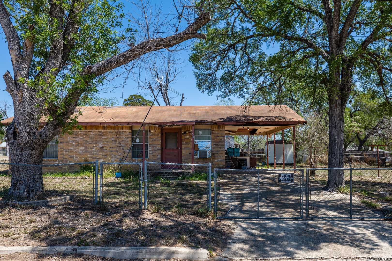 354 6th Poteet, TX 78065 - Photo 2 of 11 a backyard of a house with table and chairs