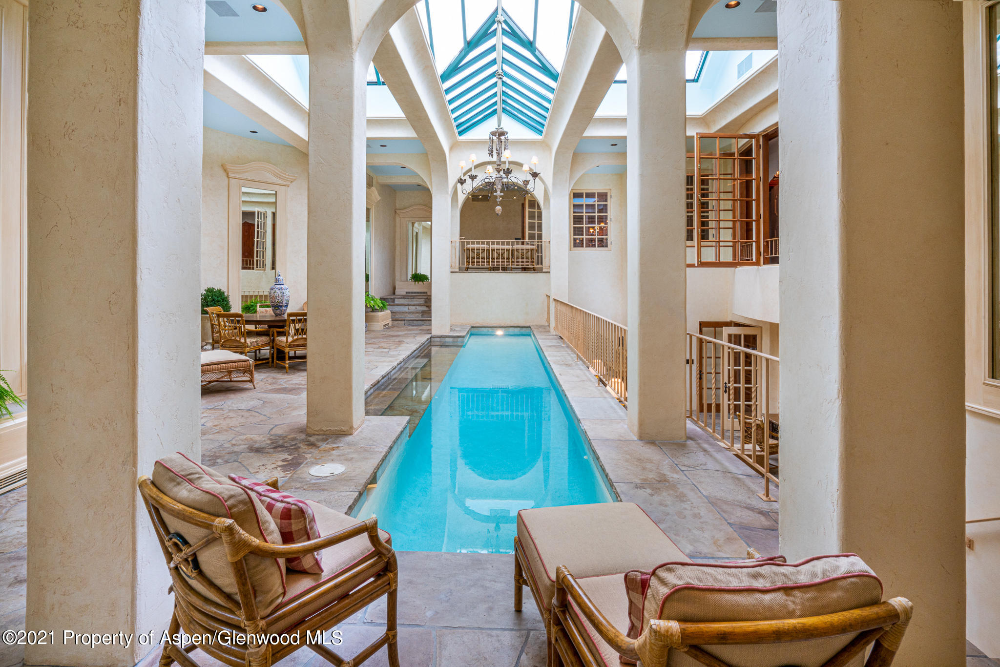 2137 Red Mountain Road Aspen, CO 81612 - Photo 12 of 59 a living room with a couch and a chandelier