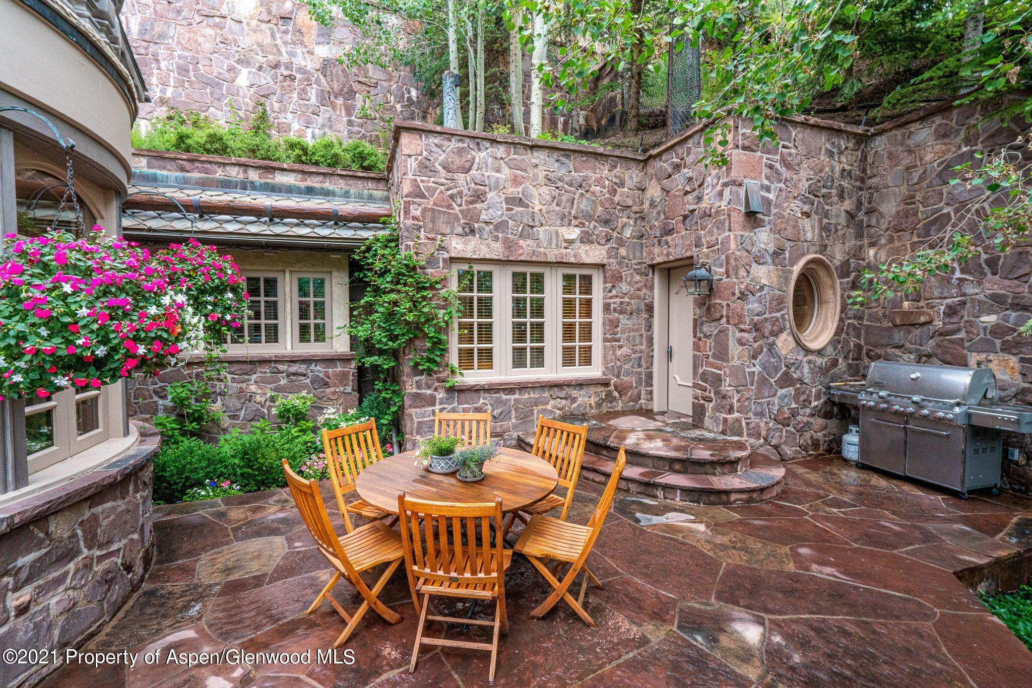 2137 Red Mountain Road Aspen, CO 81612 - Photo 23 of 59 a view of a patio with couple of chairs and a table