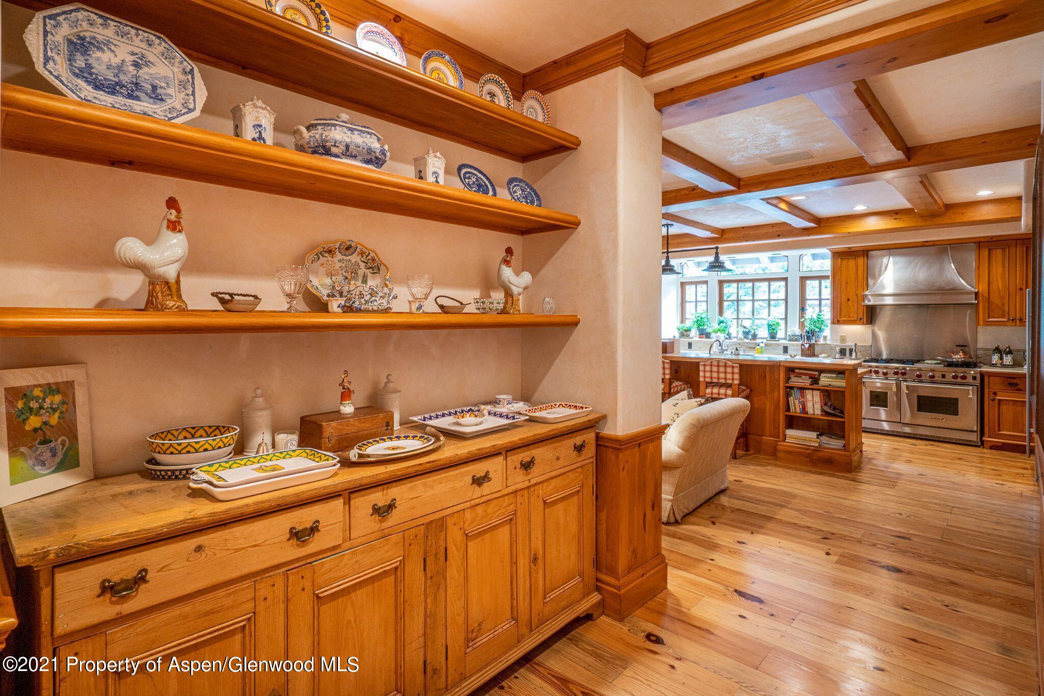 2137 Red Mountain Road Aspen, CO 81612 - Photo 24 of 59 a kitchen with stainless steel appliances granite countertop a lot of cabinets a stove and a wooden floors