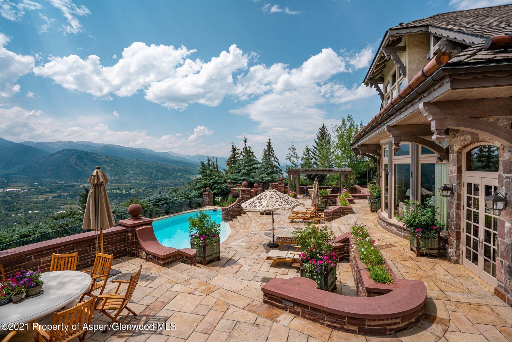 2137 Red Mountain Road Aspen, CO 81612 - Photo 28 of 59 a view of a swimming pool with a patio and a fountain