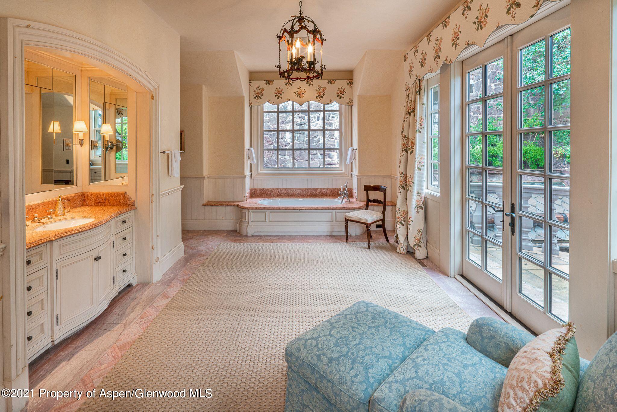 2137 Red Mountain Road Aspen, CO 81612 - Photo 29 of 59 a spacious bedroom with furniture and a large window