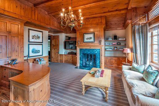 2137 Red Mountain Road Aspen, CO 81612 - Photo 32 of 59 a living room with fireplace furniture and a chandelier