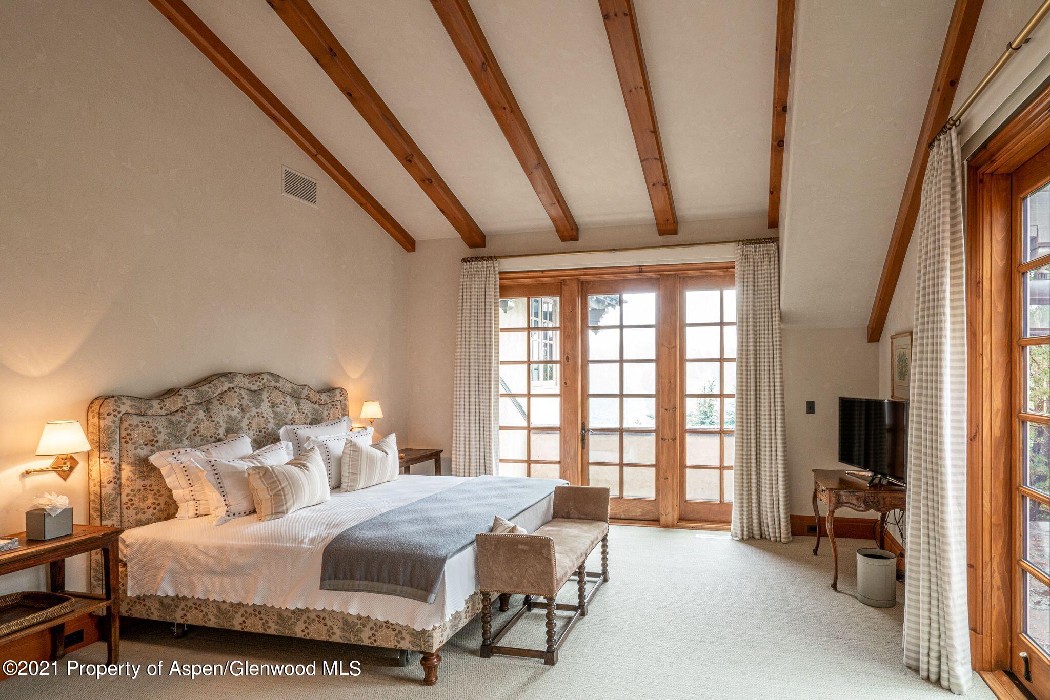 2137 Red Mountain Road Aspen, CO 81612 - Photo 33 of 59 a bedroom with furniture and a large window