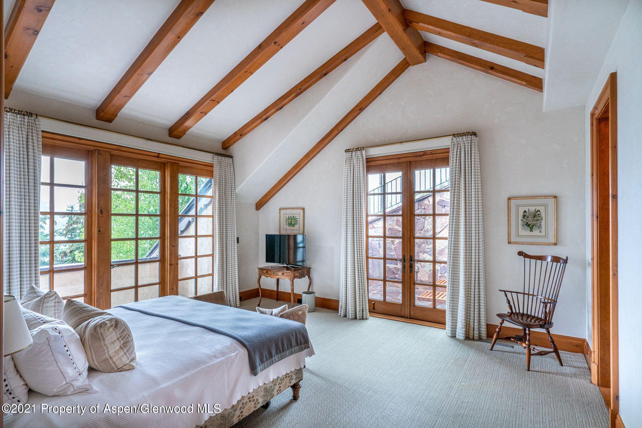 2137 Red Mountain Road Aspen, CO 81612 - Photo 34 of 59 a bedroom with a bed and a large window