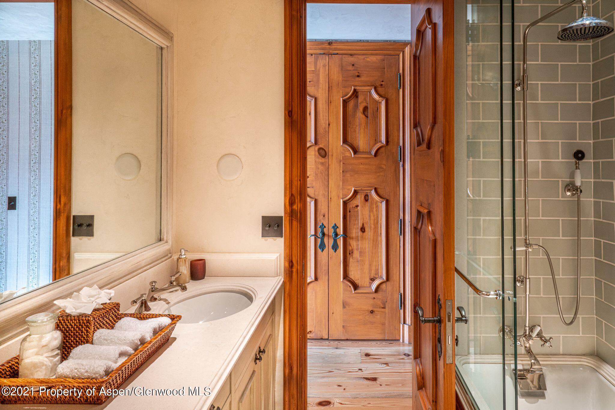 2137 Red Mountain Road Aspen, CO 81612 - Photo 38 of 59 a bathroom with a tub sink and mirror
