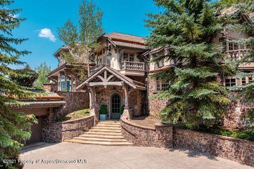 2137 Red Mountain Road Aspen, CO 81612 - Photo 4 of 59 a front view of a house with a garden