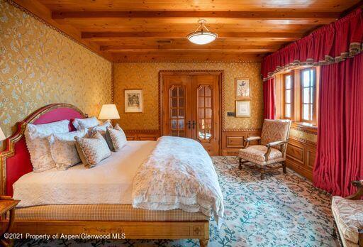 2137 Red Mountain Road Aspen, CO 81612 - Photo 43 of 59 a bedroom with a bed a mirror and a window