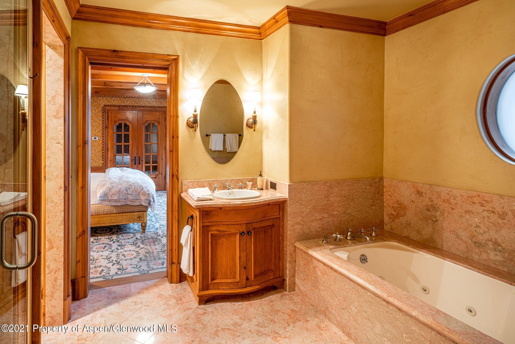 2137 Red Mountain Road Aspen, CO 81612 - Photo 44 of 59 a en suite bathroom with a granite countertop tub sink and mirror