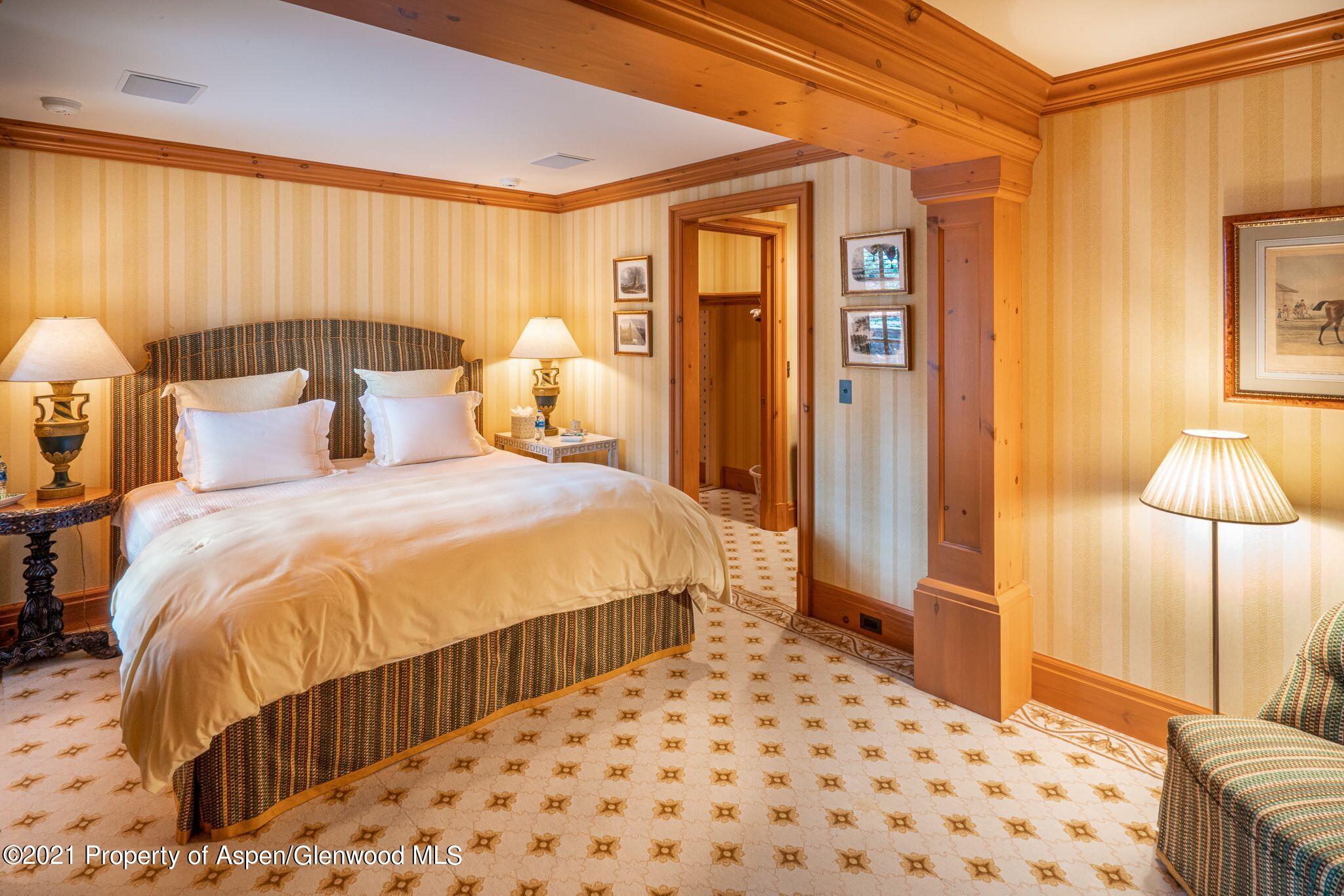 2137 Red Mountain Road Aspen, CO 81612 - Photo 47 of 59 a bedroom with a bed and a lamp