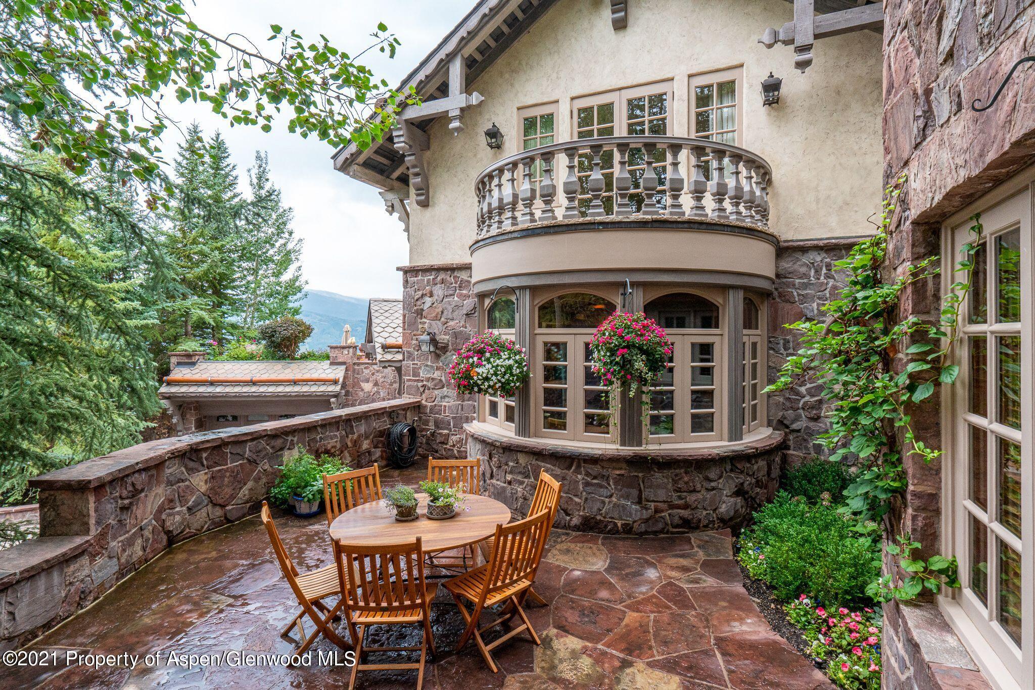 2137 Red Mountain Road Aspen, CO 81612 - Photo 49 of 59 a view of a patio with a table and chairs and potted plants
