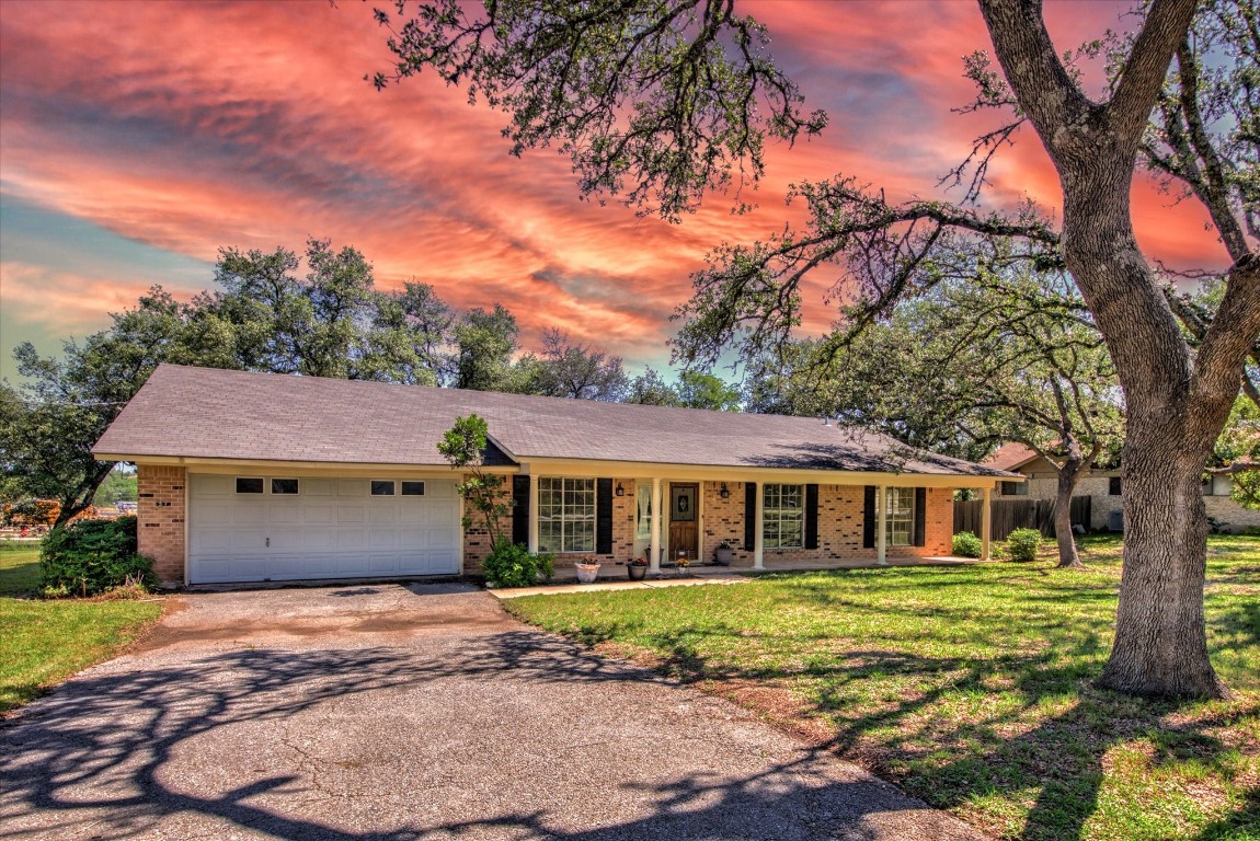 7806 Phoenix Pass Austin, TX 78737 - Photo 1 of 1 a view of a white house with a large windows yard and a large tree