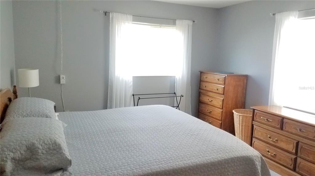 1801 Restful Drive, Unit N7 Bradenton, FL 34207 - Photo 11 of 24 a bedroom with a bed and a dresser in it