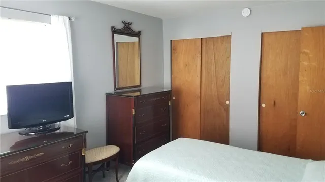 a bathroom with a toilet a sink a mirror a vanity and shower