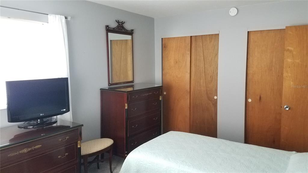 1801 Restful Drive, Unit N7 Bradenton, FL 34207 - Photo 12 of 24 a bathroom with a toilet a sink a mirror a vanity and shower