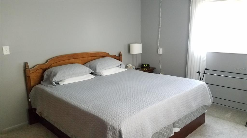 1801 Restful Drive, Unit N7 Bradenton, FL 34207 - Photo 14 of 24 a bedroom with a bed and a refrigerator