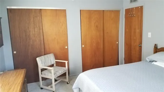 a bedroom with a bed and chair