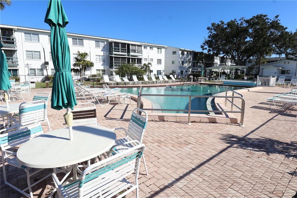 1801 Restful Drive, Unit N7 Bradenton, FL 34207 - Photo 20 of 24 a swimming pool with outdoor seating and yard