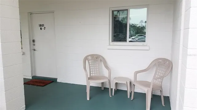 a couple of chairs sitting next to a window