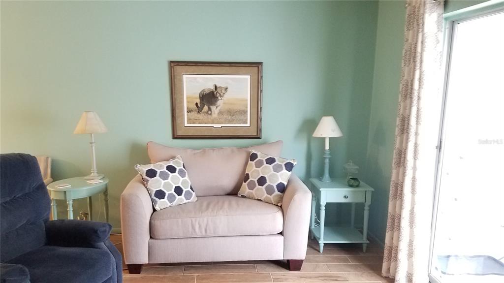 1801 Restful Drive, Unit N7 Bradenton, FL 34207 - Photo 3 of 24 a bedroom with a bed and a painting on the wall