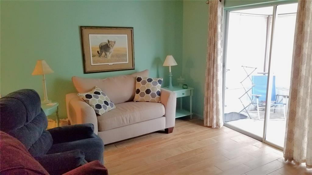 1801 Restful Drive, Unit N7 Bradenton, FL 34207 - Photo 5 of 24 a living room with furniture and a large window