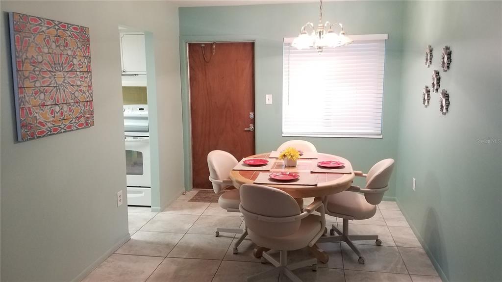 1801 Restful Drive, Unit N7 Bradenton, FL 34207 - Photo 6 of 24 a dining room with furniture and window
