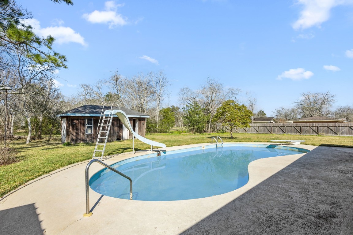 13038 4th Street Santa Fe, TX 77510 - Photo 23 of 39 a view of a swimming pool with an outdoor seating and yard