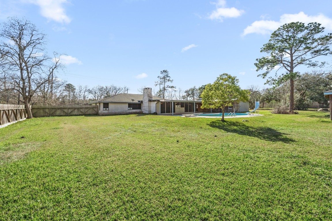 13038 4th Street Santa Fe, TX 77510 - Photo 27 of 39 a view of a house with a yard and a garden
