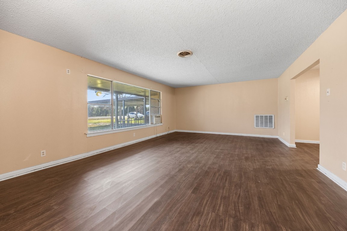 13038 4th Street Santa Fe, TX 77510 - Photo 5 of 39 an empty room with wooden floor and windows