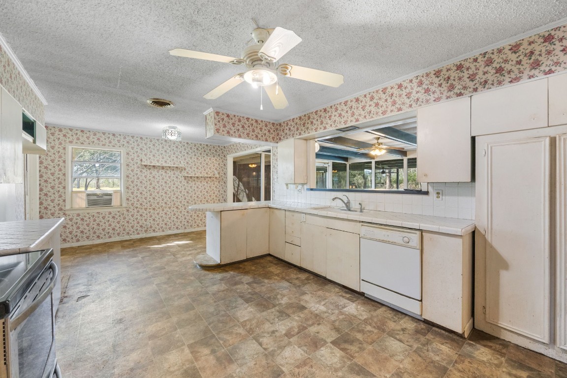 13038 4th Street Santa Fe, TX 77510 - Photo 9 of 39 a kitchen with white cabinets and white appliances