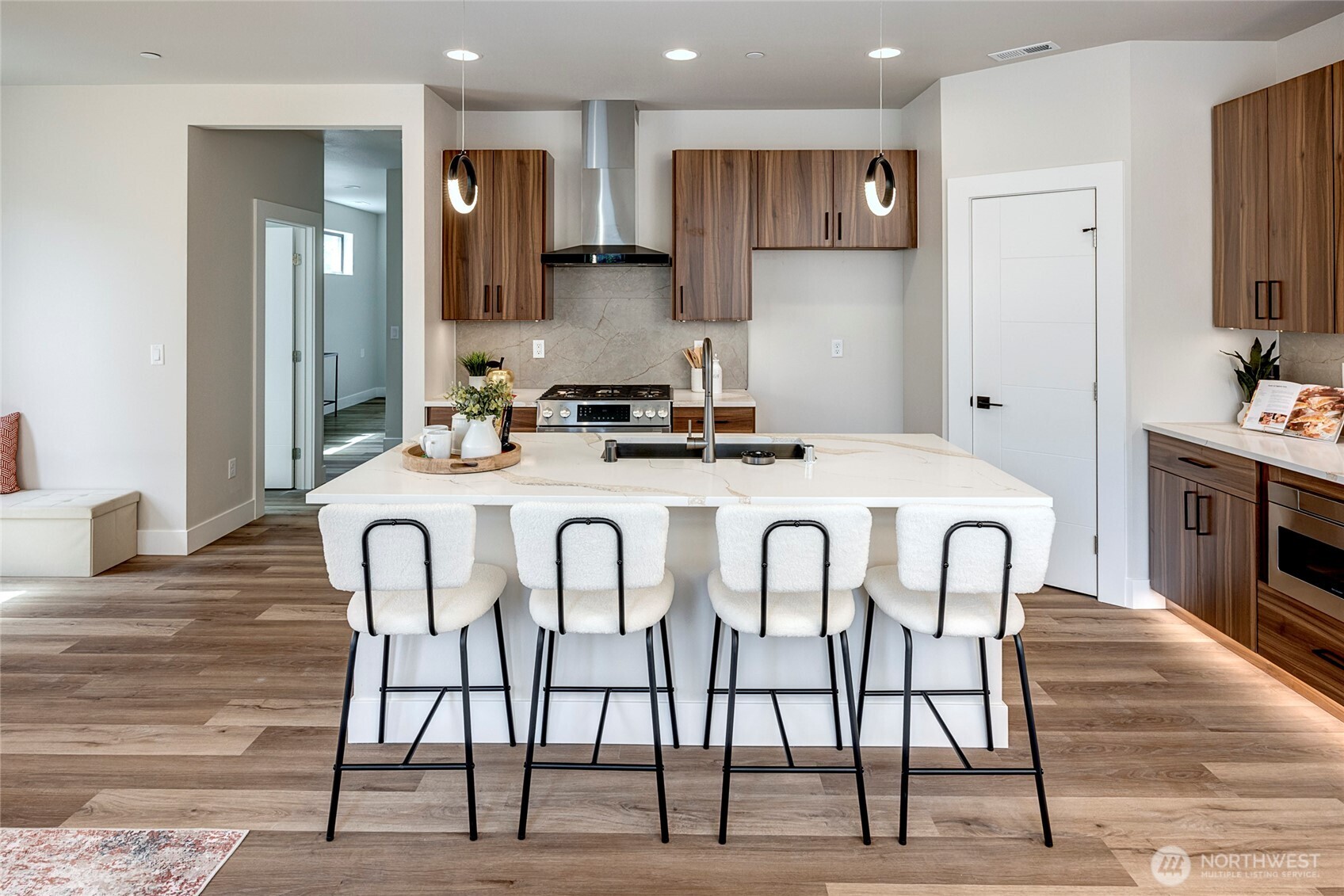 3926 214th Place Southeast, Unit B Bothell, WA 98021 - Photo 17 of 30 a kitchen with stainless steel appliances kitchen island granite countertop a dining table chairs sink and cabinets