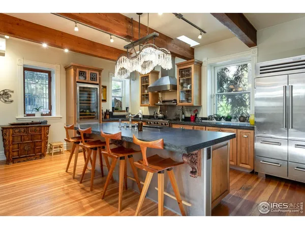 a large kitchen with stainless steel appliances granite countertop a sink and cabinets