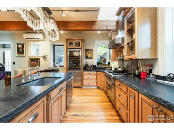 a kitchen with stainless steel appliances granite countertop a stove and a microwave