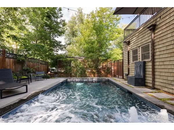 a backyard of a house with yard and outdoor seating