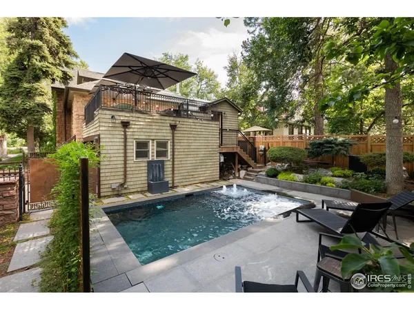 a pool with table and chairs