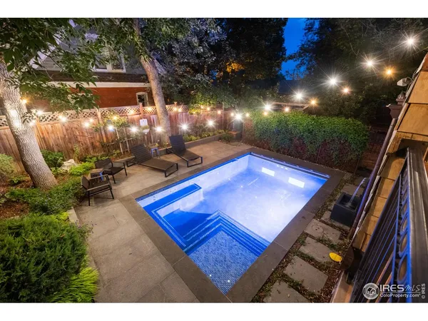 a view of a patio with table and chairs a barbeque with wooden fence