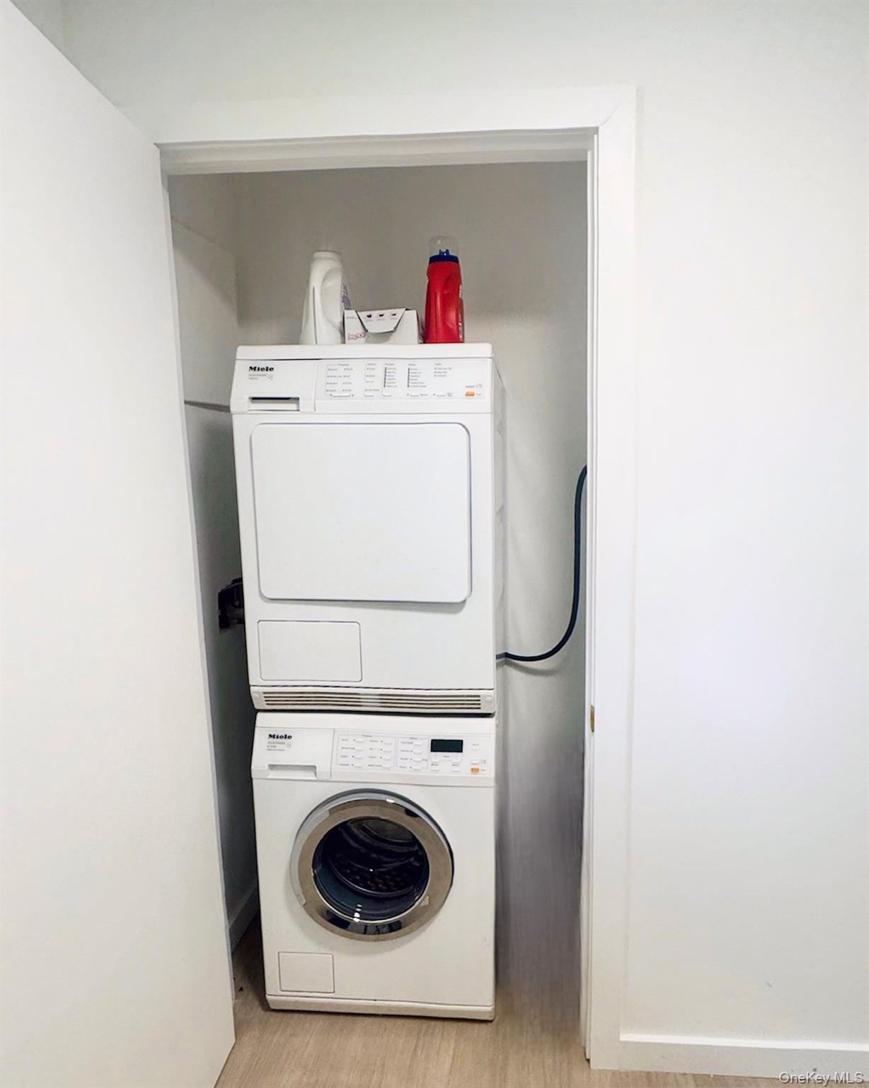 67 West Shore Road Kauneonga Lake, NY 12749 - Photo 15 of 17 Laundry room with estacked washer and dryer and light wood-type flooring