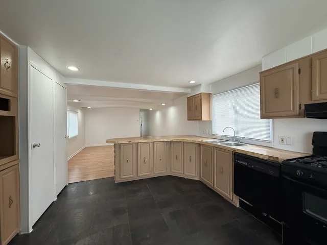 a kitchen with sink and cabinets