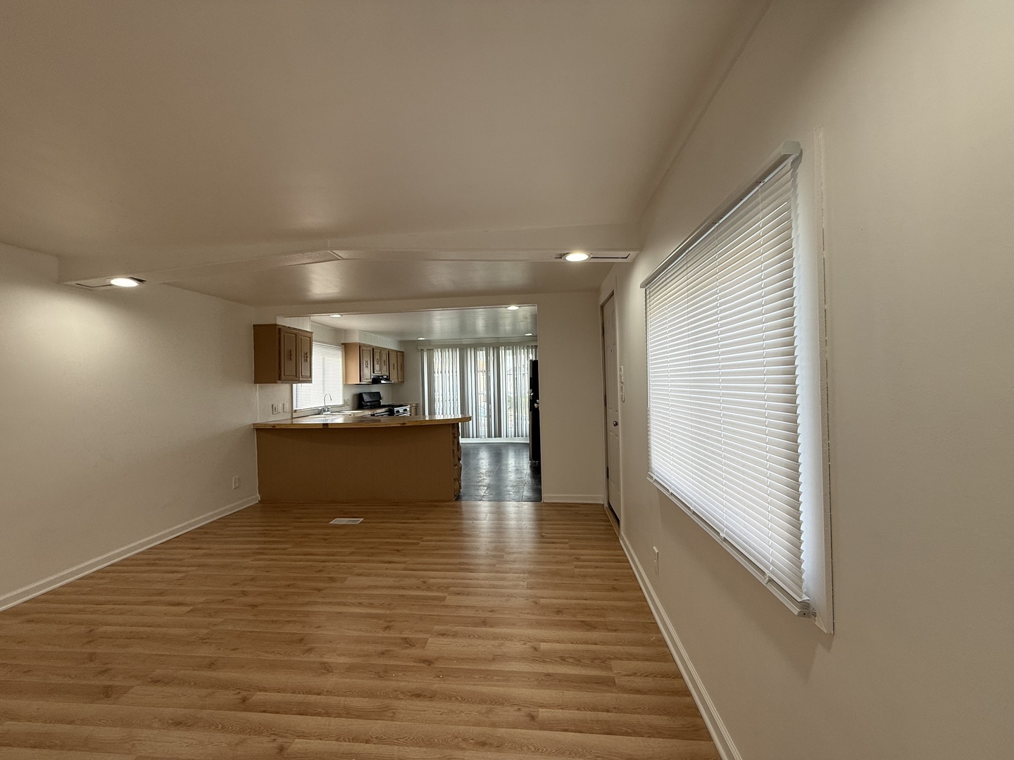 605 Tanglewood Road Matteson, IL 60443 - Photo 7 of 18 a view of a kitchen with kitchen island a sink wooden floor and a large window