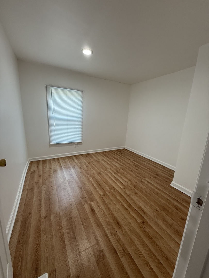 605 Tanglewood Road Matteson, IL 60443 - Photo 8 of 18 a view of empty room with wooden floor