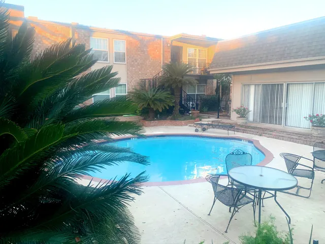 a swimming pool with outdoor seating and yard