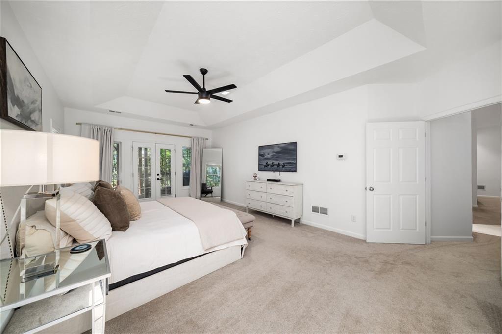 16218 Henderson Road Milton, GA 30004 - Photo 25 of 70 a bedroom with bed tv and window