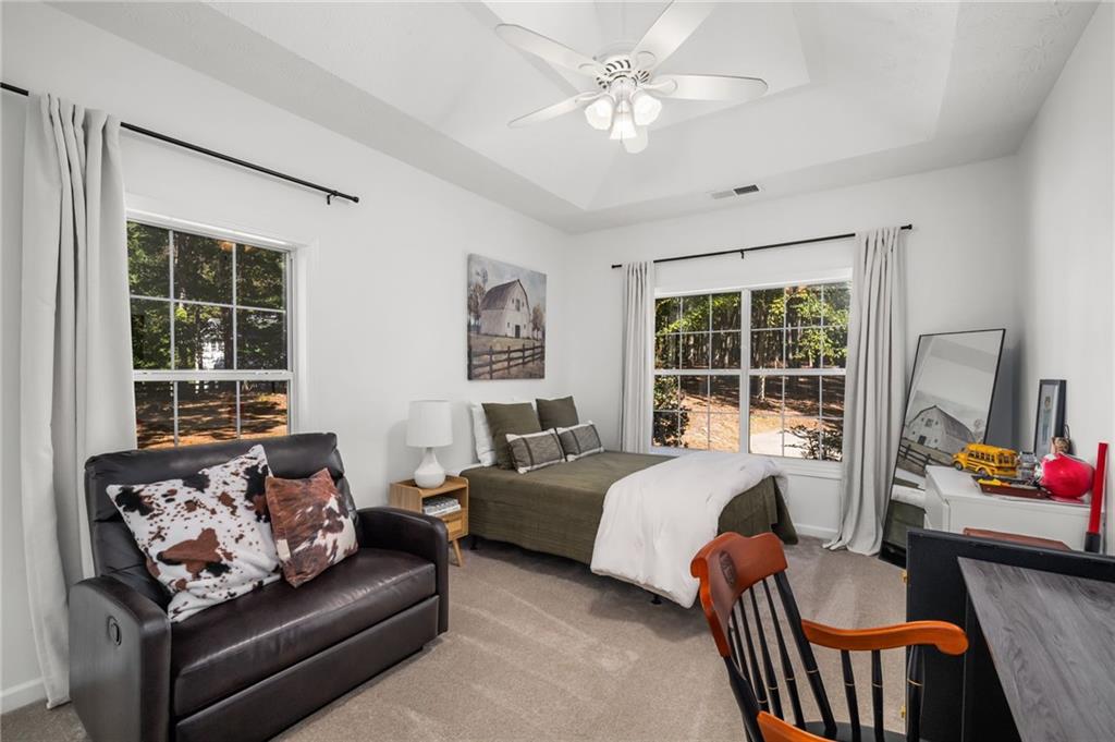 16218 Henderson Road Milton, GA 30004 - Photo 31 of 70 a spacious bedroom with a bed and a window