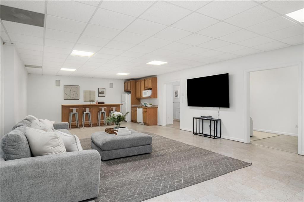 16218 Henderson Road Milton, GA 30004 - Photo 38 of 70 a living room with furniture and a flat screen tv