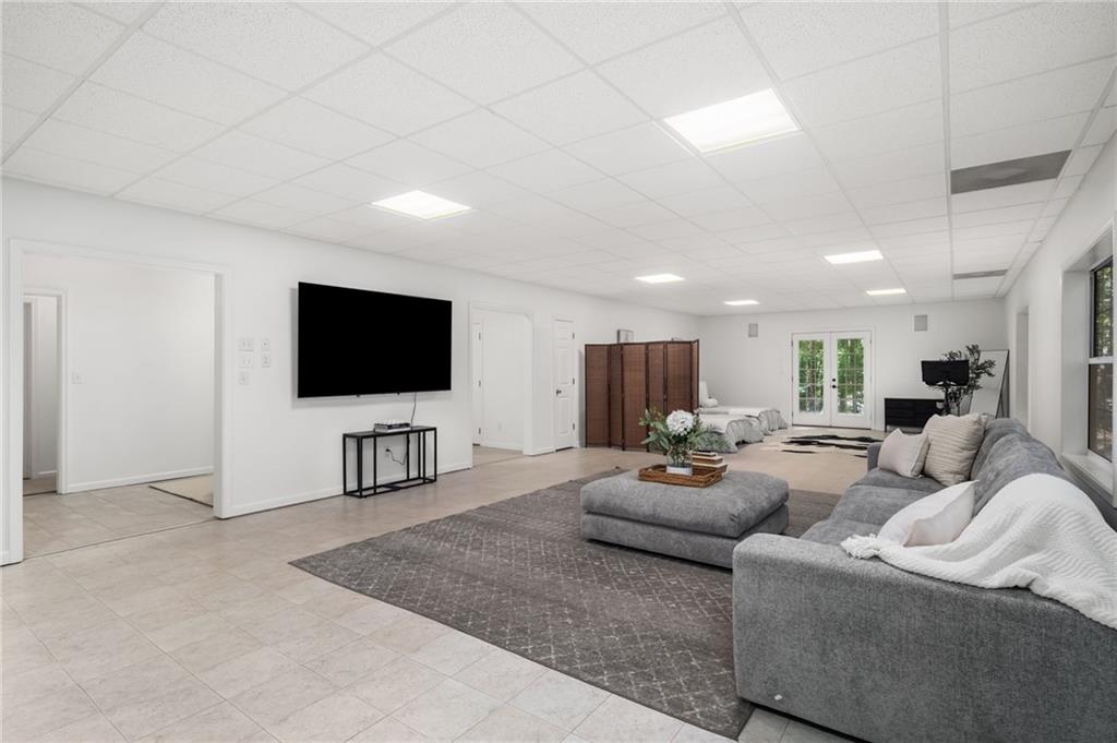 16218 Henderson Road Milton, GA 30004 - Photo 41 of 70 a living room with furniture and a flat screen tv