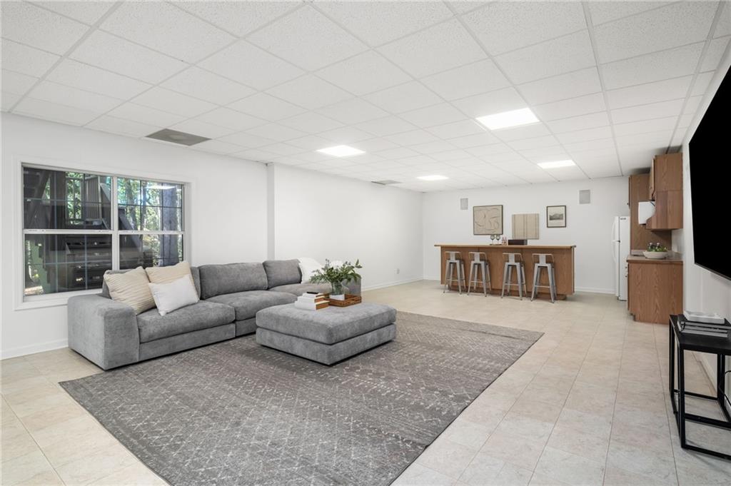 16218 Henderson Road Milton, GA 30004 - Photo 42 of 70 a living room with furniture and a flat screen tv