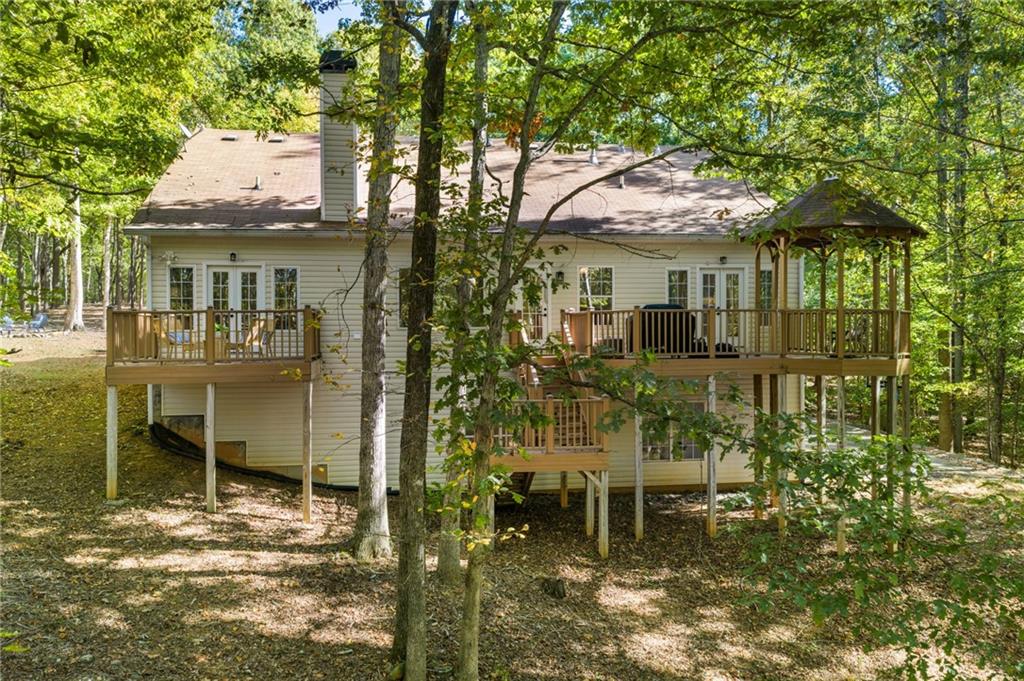 16218 Henderson Road Milton, GA 30004 - Photo 47 of 70 a yellow house with table and chairs in front of it
